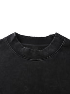 Close-up of a black garment with a textured collar on a white background