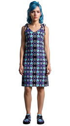 Woman wearing a patterned dress with blue hair against a plain background